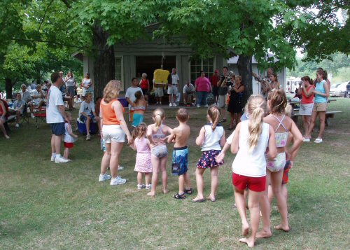 The children try their luck on the pinata - click for a larger view.